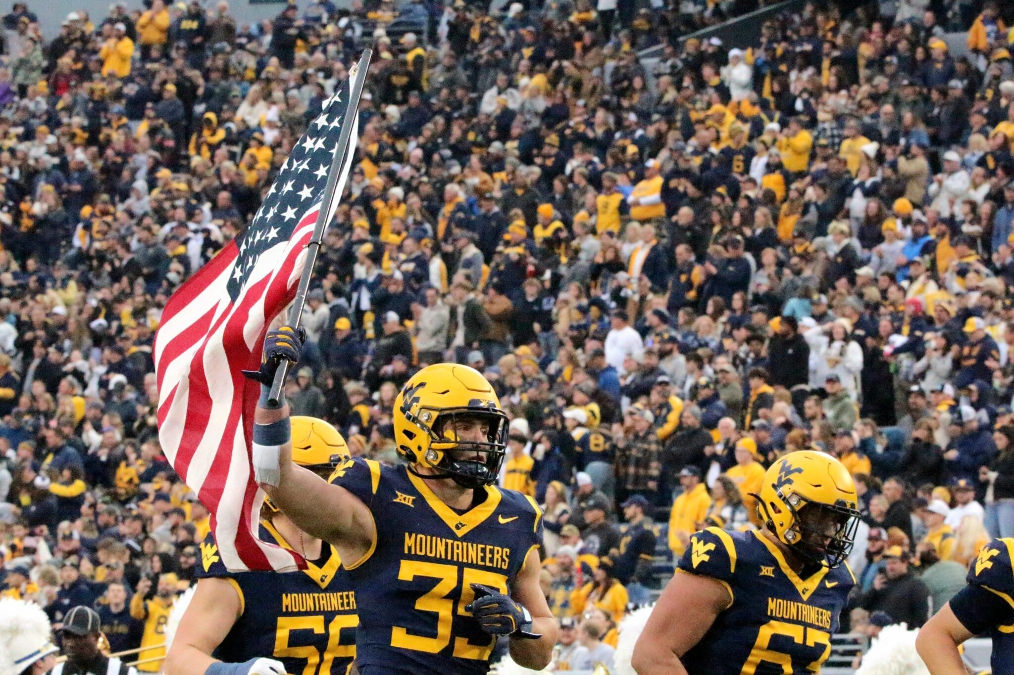 WVU Football Reid Carrico with US flag
