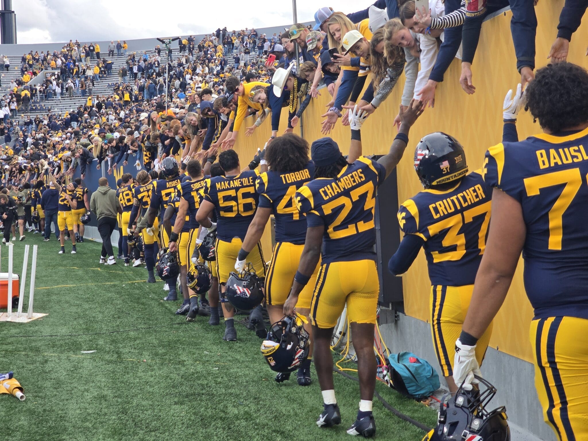 WVU Football players with fans