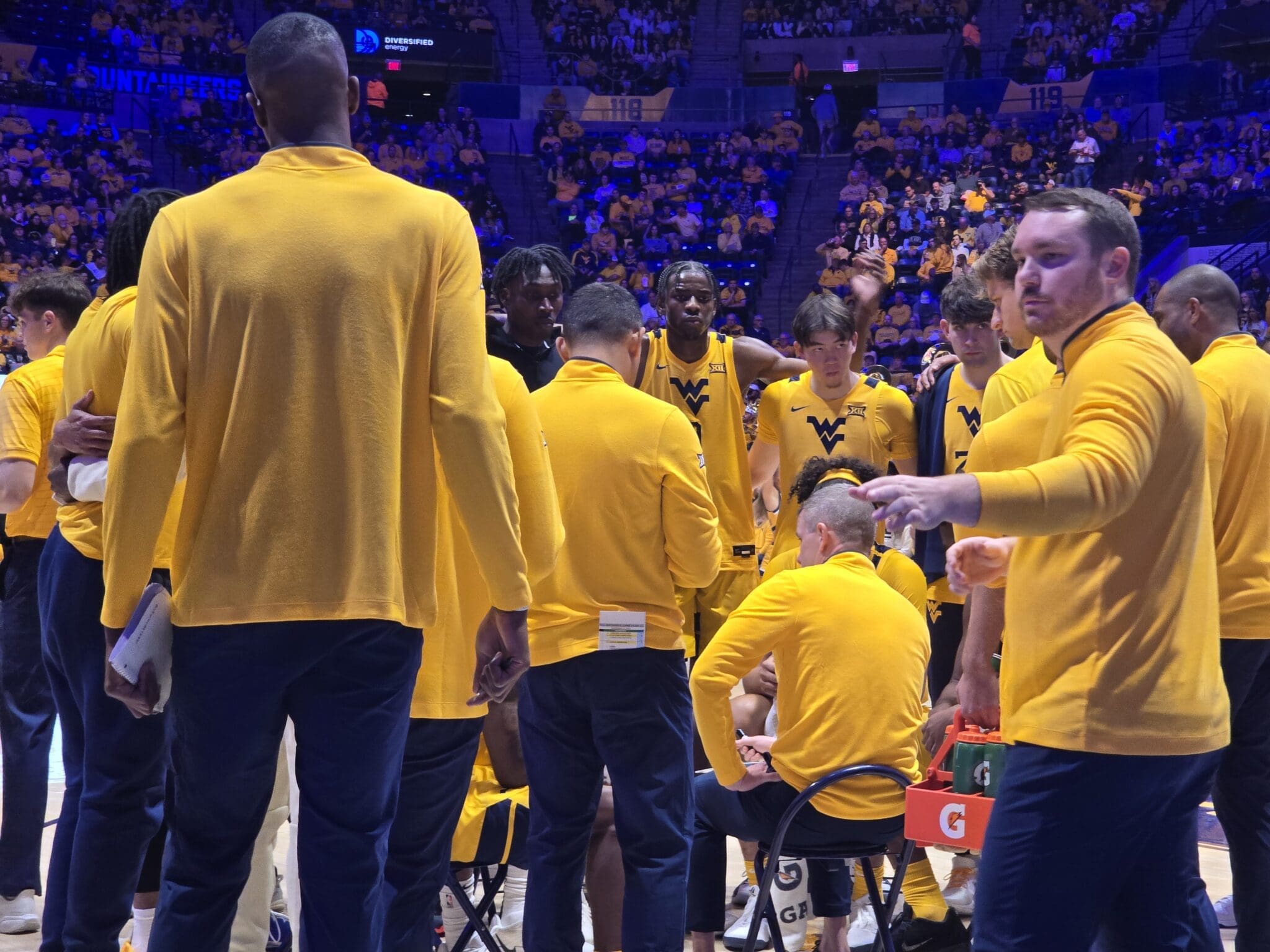 WVU Basketball HC Ross Hodge in huddle