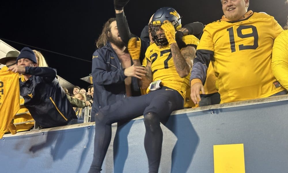 WVU Football Safety Davis Mallinger celebrates the win with fans