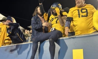WVU Football Safety Davis Mallinger celebrates the win with fans