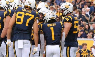 WVU Football Offense huddle with Jahiem White and Kole Taylor