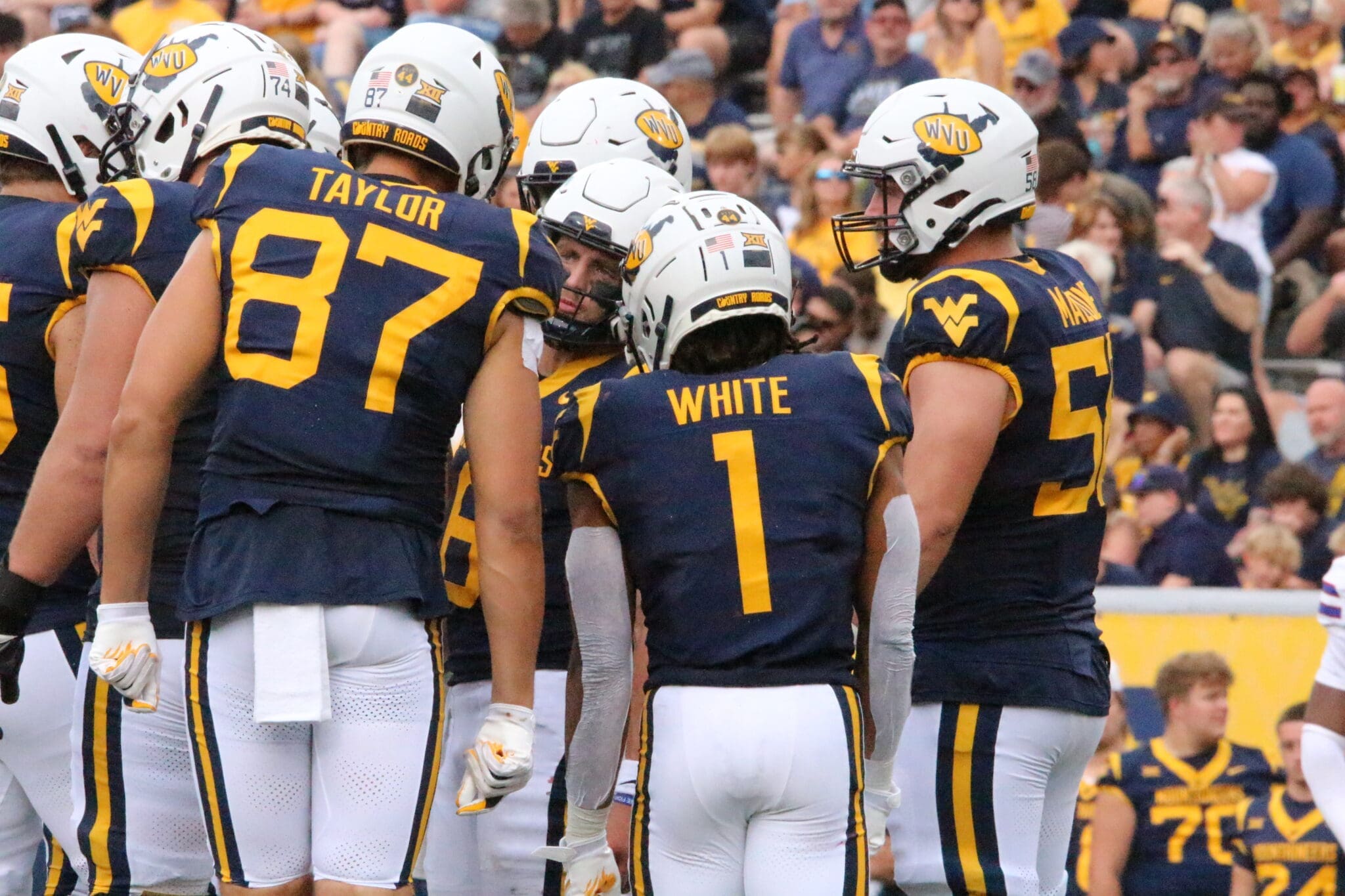 WVU Football Offense huddle with Jahiem White and Kole Taylor