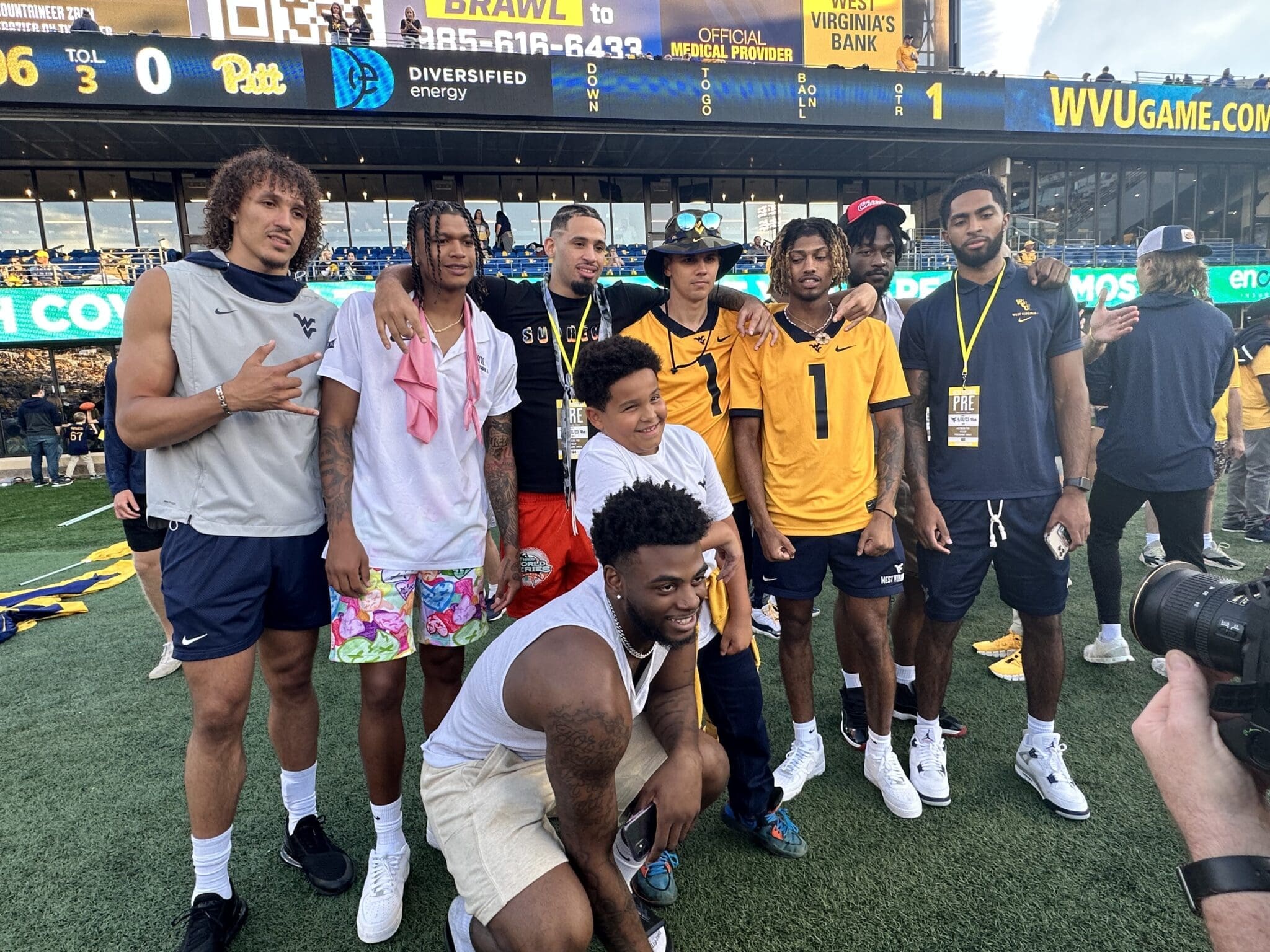WVU Basketball Players on football field