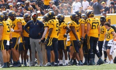 WVU Football WR Coach Bilal Marshall and receivers on sideline stock photo