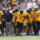 WVU Football WR Coach Bilal Marshall and receivers on sideline stock photo