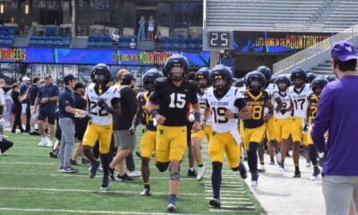 WVU Football running on field for spring scrimmage