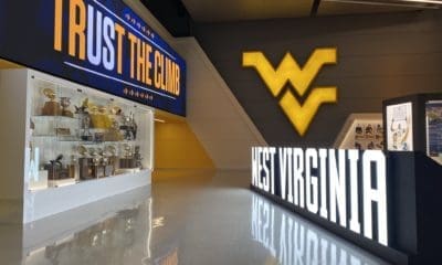 West Virginia sign at WVU Football facility with trophies stock