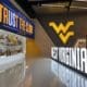 West Virginia sign at WVU Football facility with trophies stock