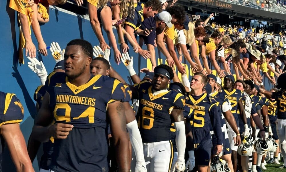WVU Football players with fans during Country Roads