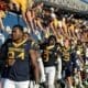 WVU Football players with fans during Country Roads