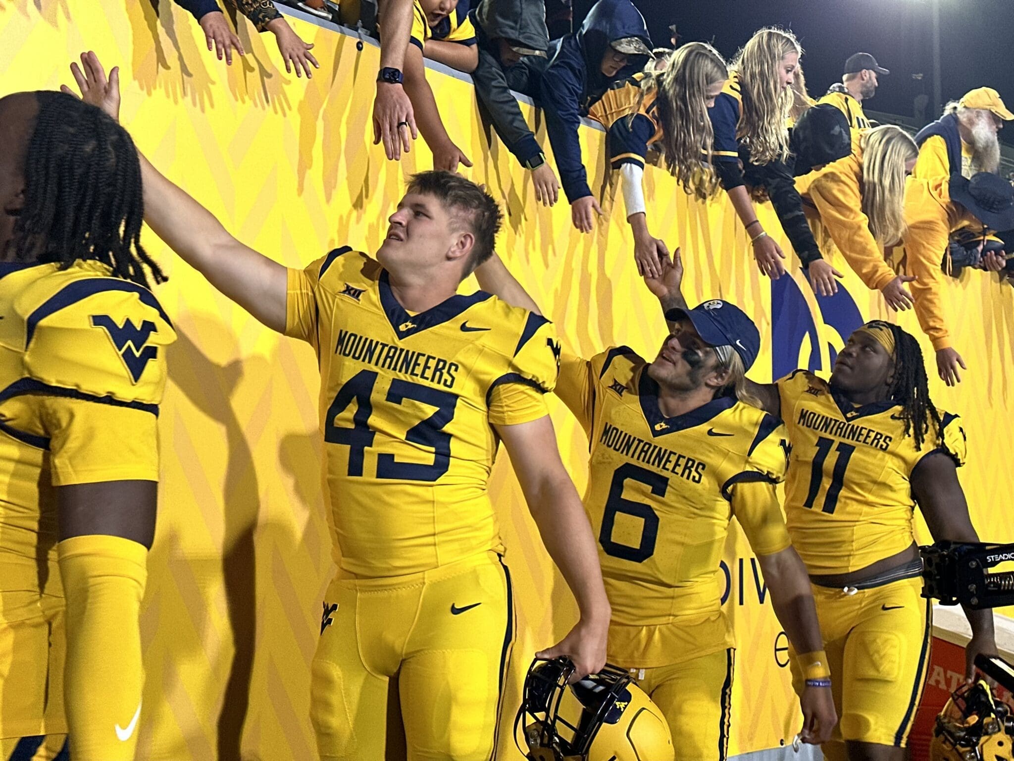 WVU fans and Garrett Greene after a win