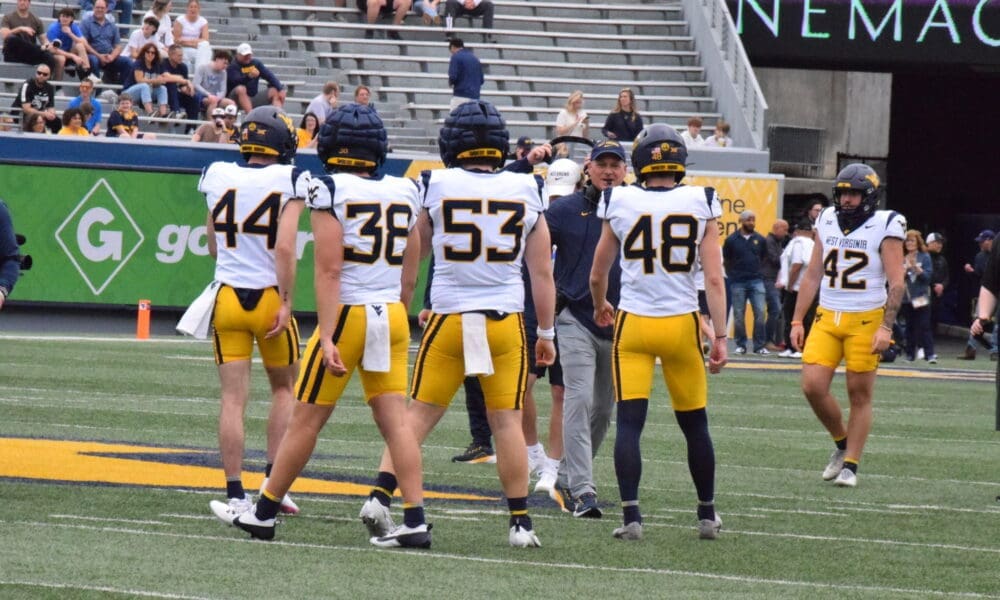 WVU Football HC Rich Rodriguez with players during Spring Showcase