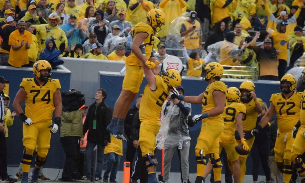 WVU Football TE Kole Taylor celebrates a TD against Texas Tech with Zach Frazier, Wyatt Milum and Doug Nester in image