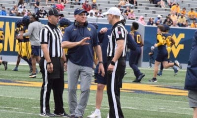 WVU Football HC Rich Rodriguez with refs during Spring Showcase