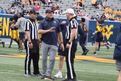 WVU Football HC Rich Rodriguez with refs during Spring Showcase