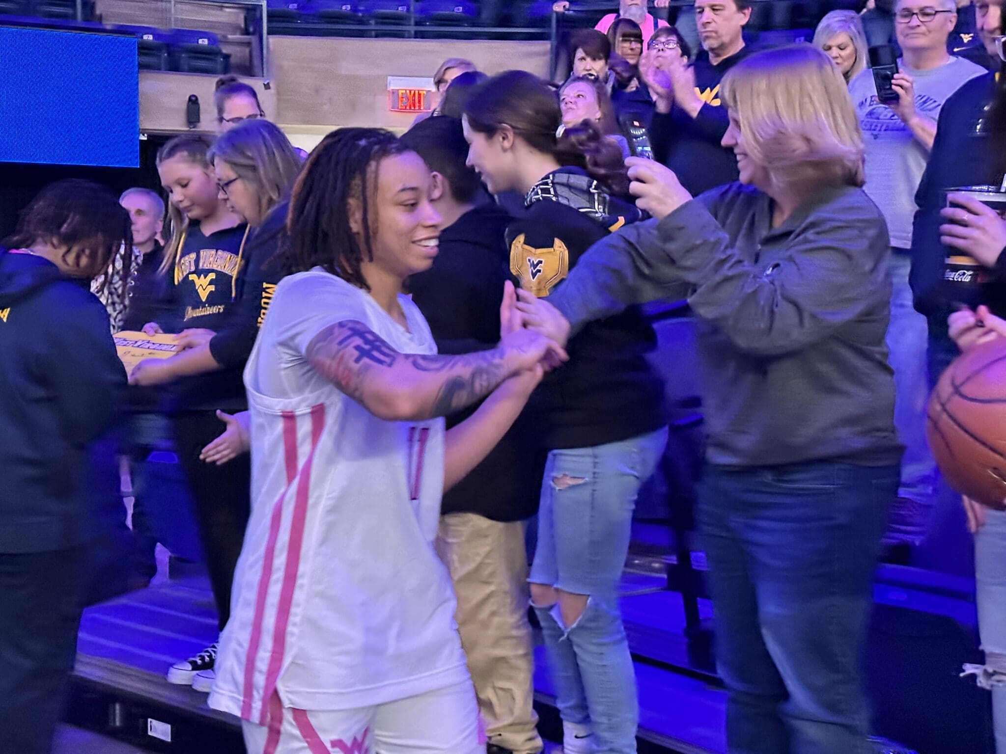 West Virginia Women's Basketball with fans JJ Quinerly
