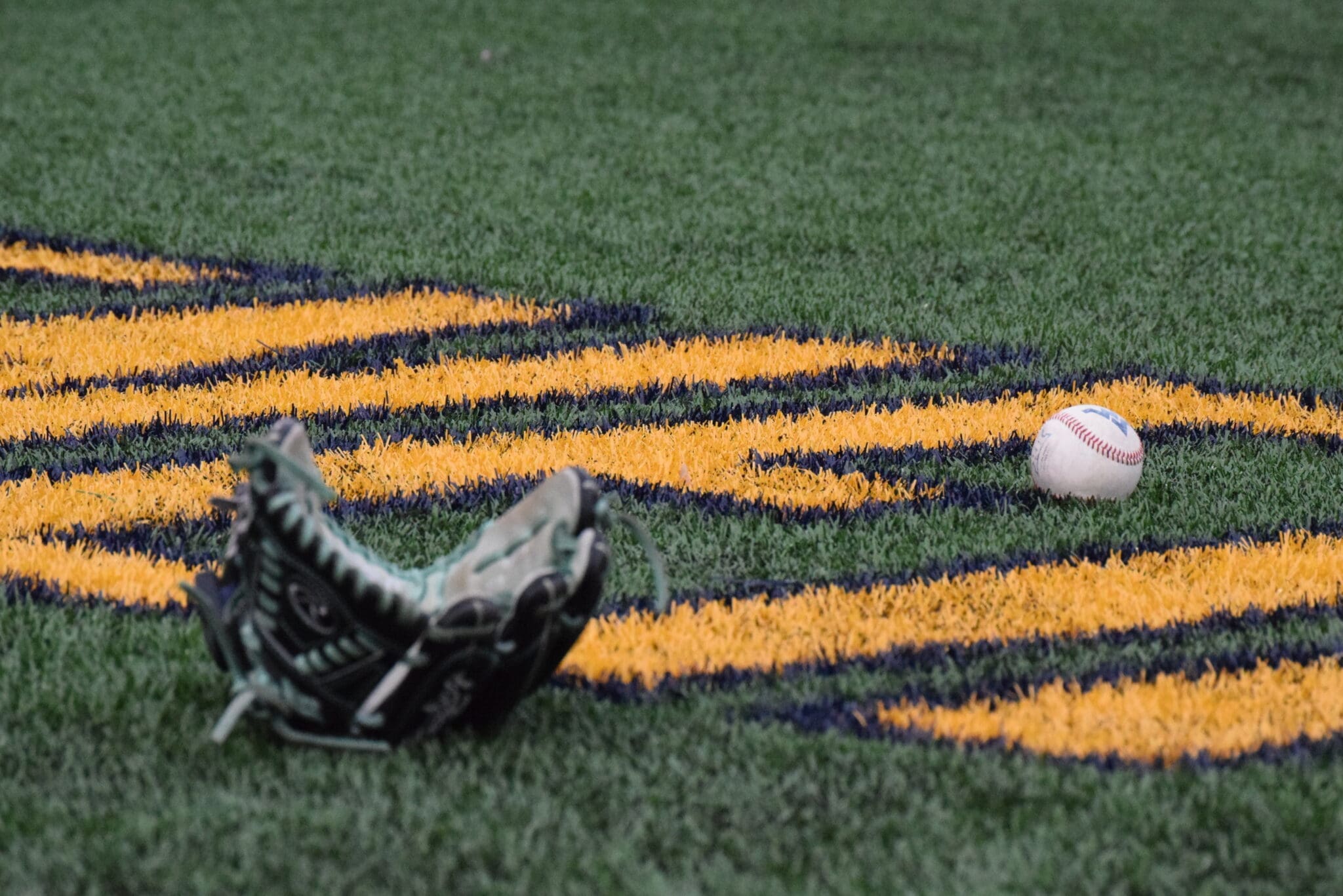 WVU Baseball glove and ball stock