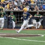 WVU Baseball Sam White touches home plate