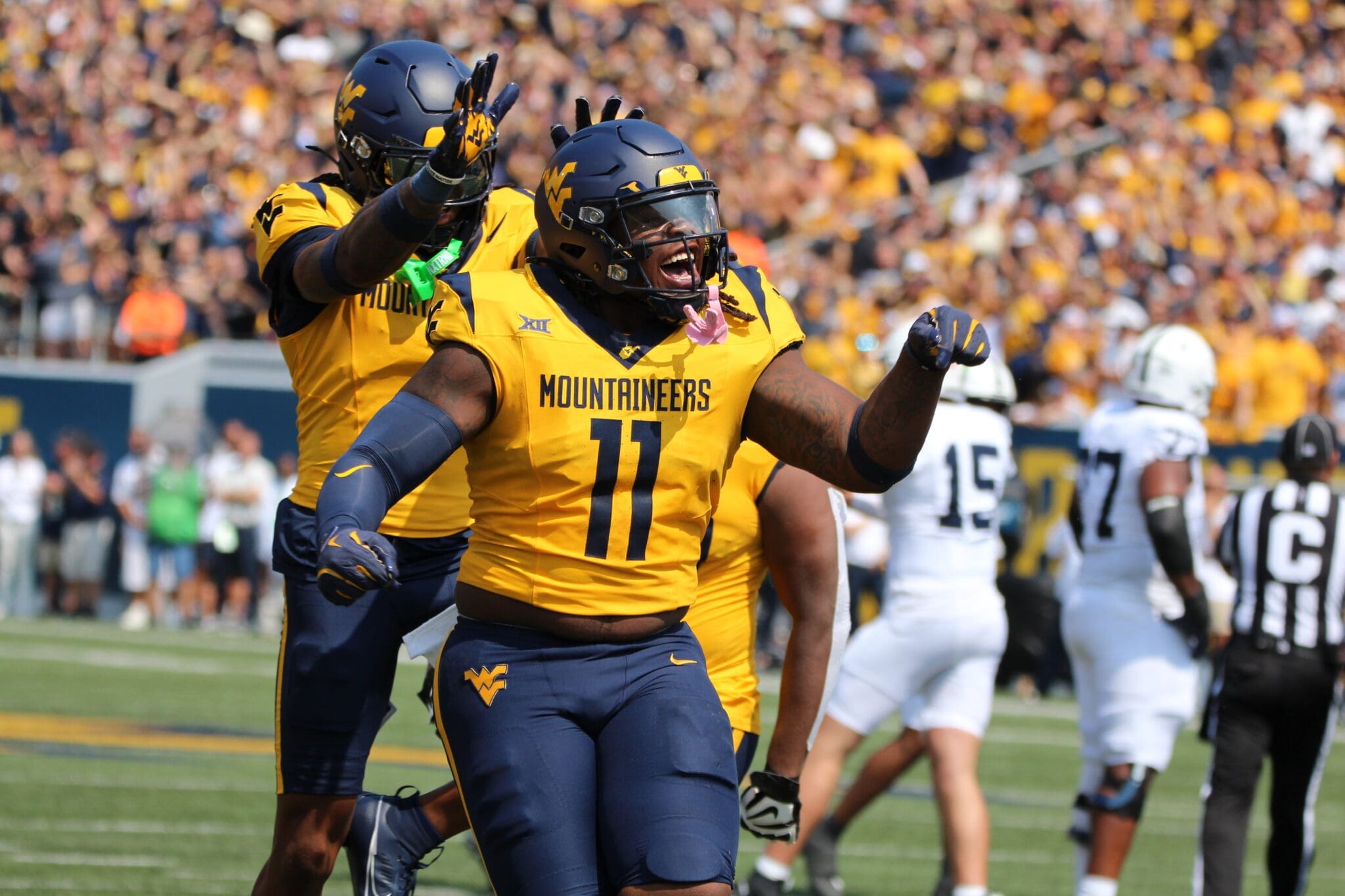 WVU Football TJ Jackson and Aubrey Burks celebrate a turnover