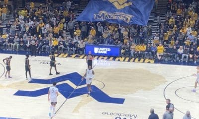 Mountaineer Maniacs flag in crowd at WVU Coliseum