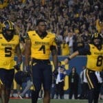 WVU Football Nicco Marchiol, CJ Donaldson with helmet off and Devin Carter