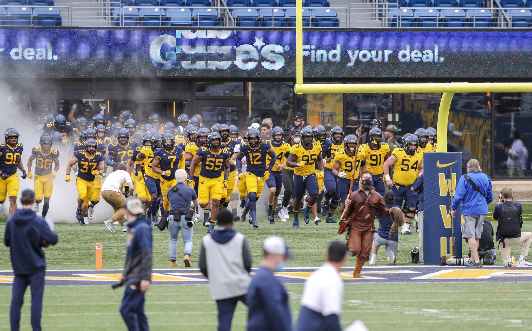 WVU football team running on field for spring game