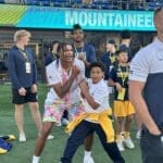 WVU basketball players on football field