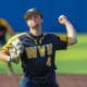 WVU pitcher Jake Carr winds up for a throw.