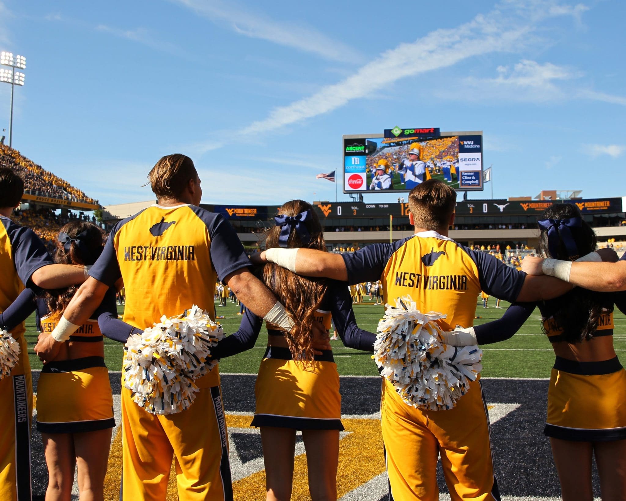 WVU cheerleaders on football field stock