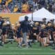 WVU Football Coach Noel Devine during warmups