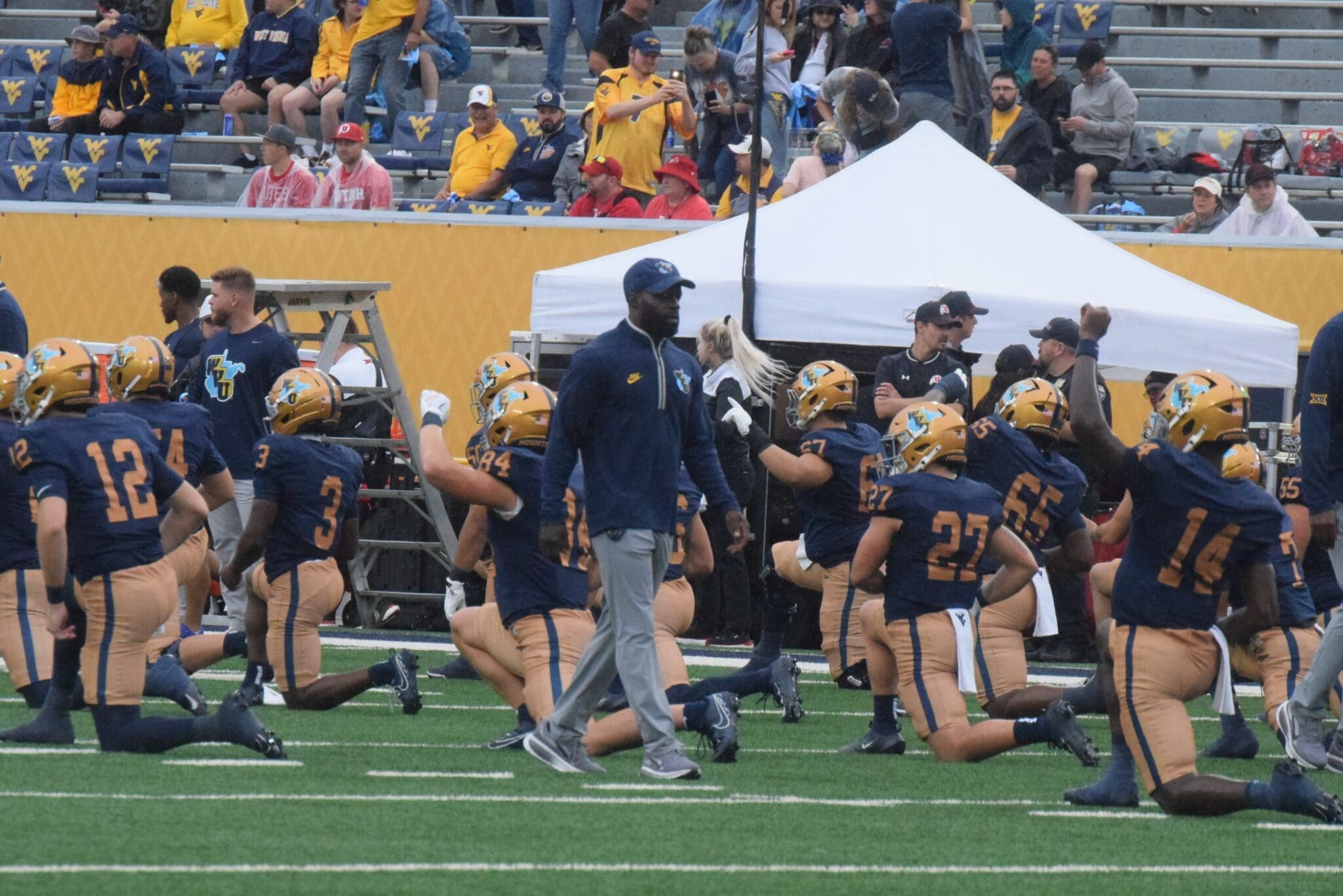 WVU Football Coach Noel Devine during warmups