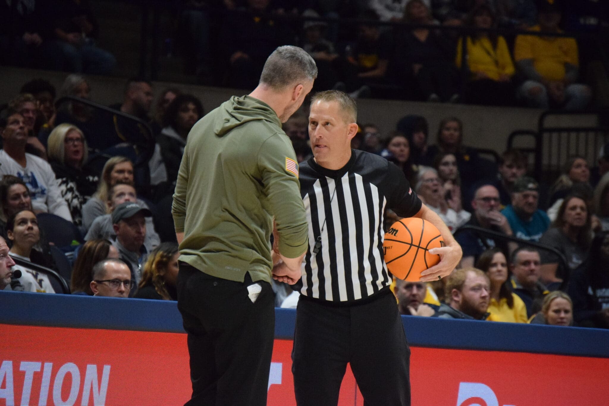 WVU Basketball Josh Eilert and Referee