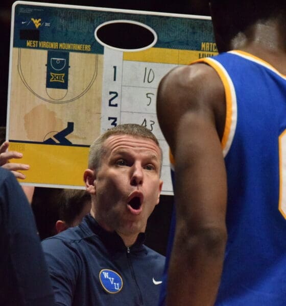 WVU Basketball HC Ross Hodge in huddle