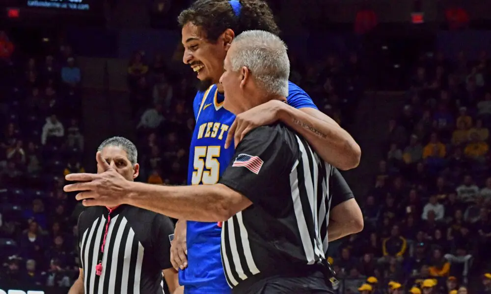 WVU Basketball Harlan Obioha with referee