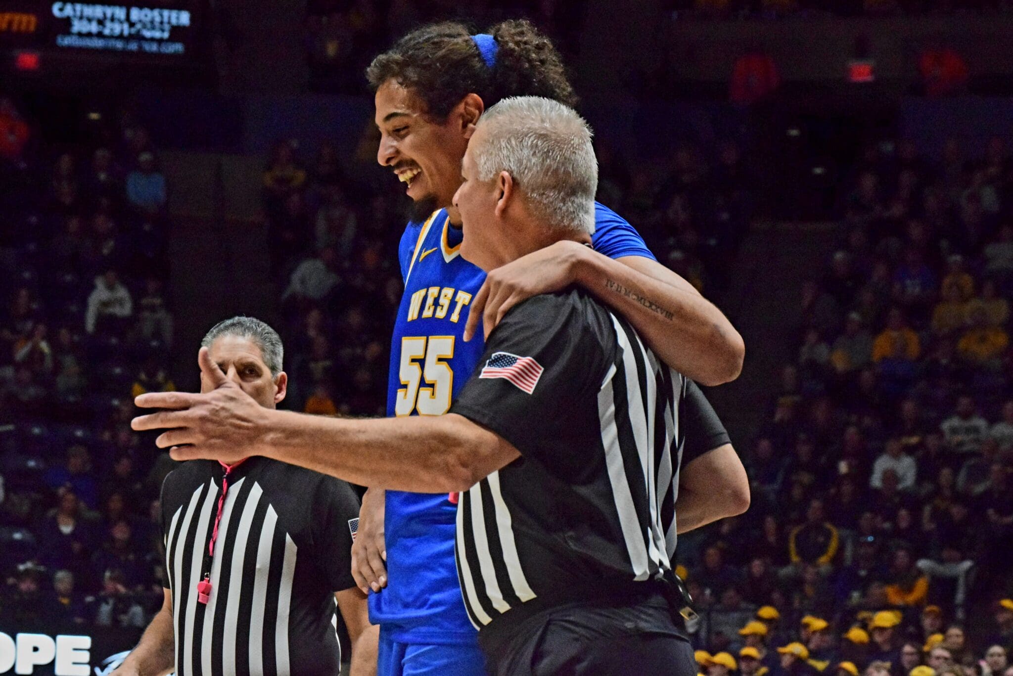 WVU Basketball Harlan Obioha with referee