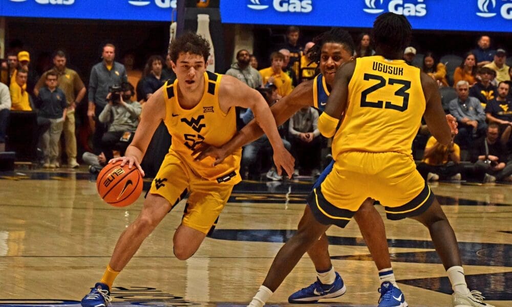 WVU Basketball Treysen Eaglestaff driving with ball against Pitt in Backyard Brawl