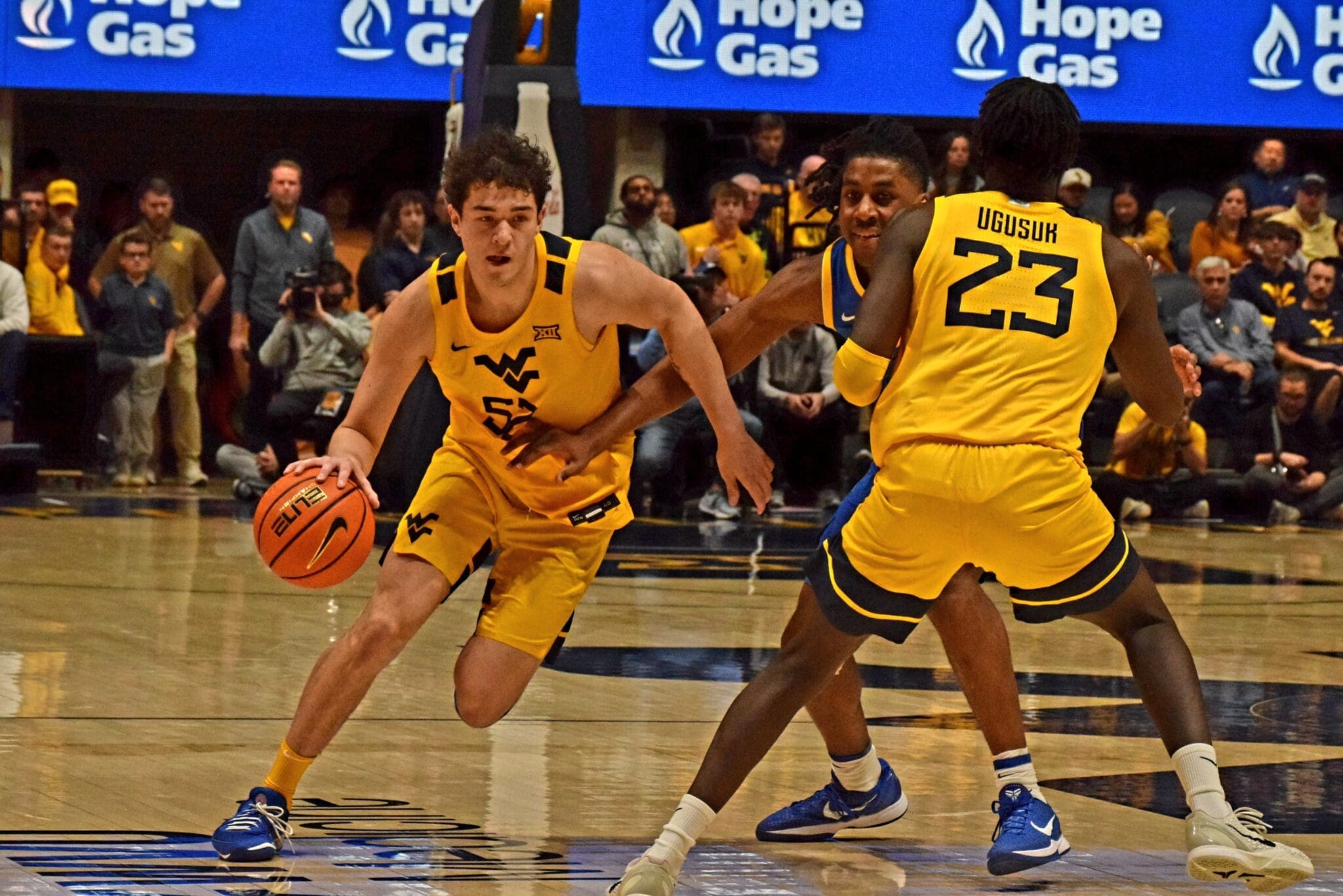 WVU Basketball Treysen Eaglestaff driving with ball against Pitt in Backyard Brawl