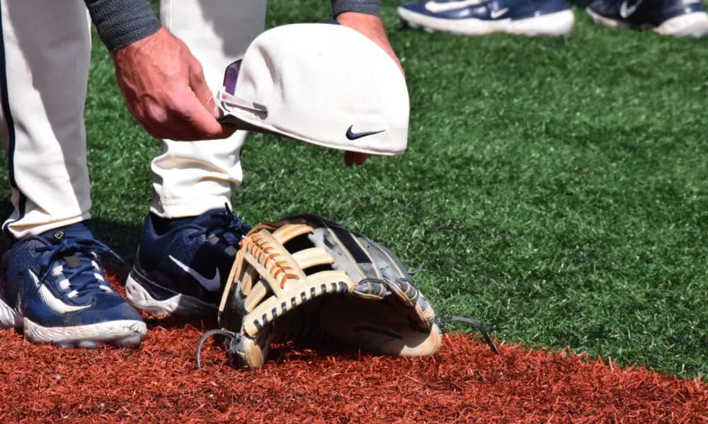 WVU Baseball hat on glove stock