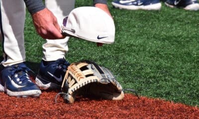 WVU Baseball hat on glove stock