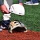 WVU Baseball hat on glove stock
