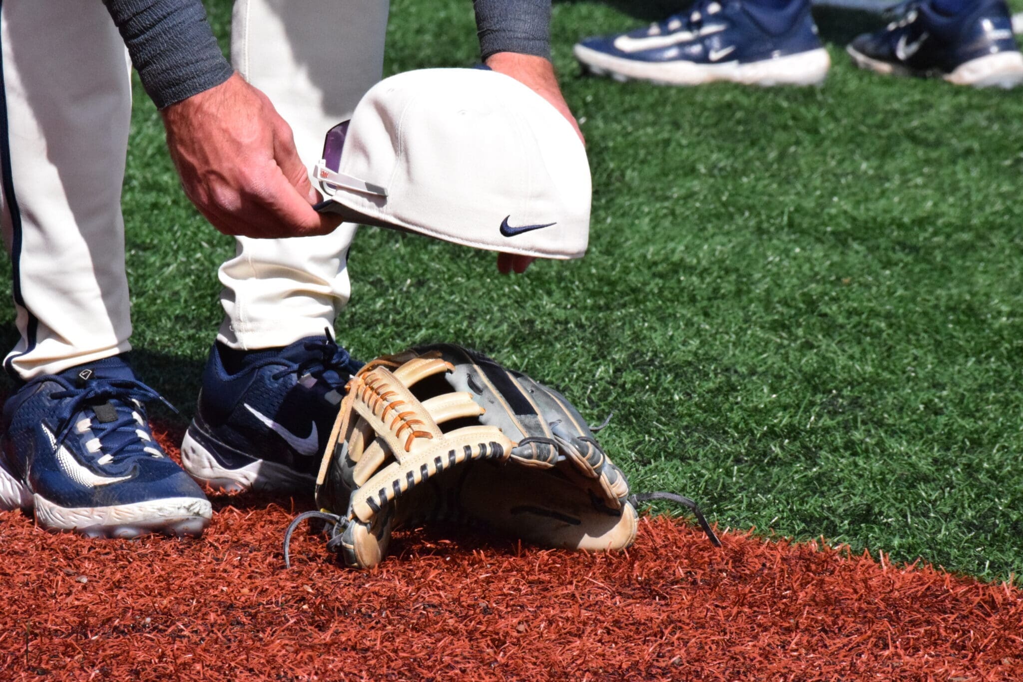 WVU Baseball hat on glove stock