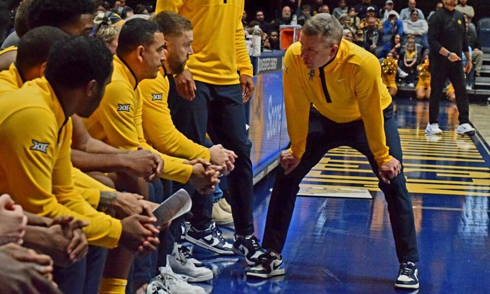 WVU Basketball HC Ross Hodge in huddle