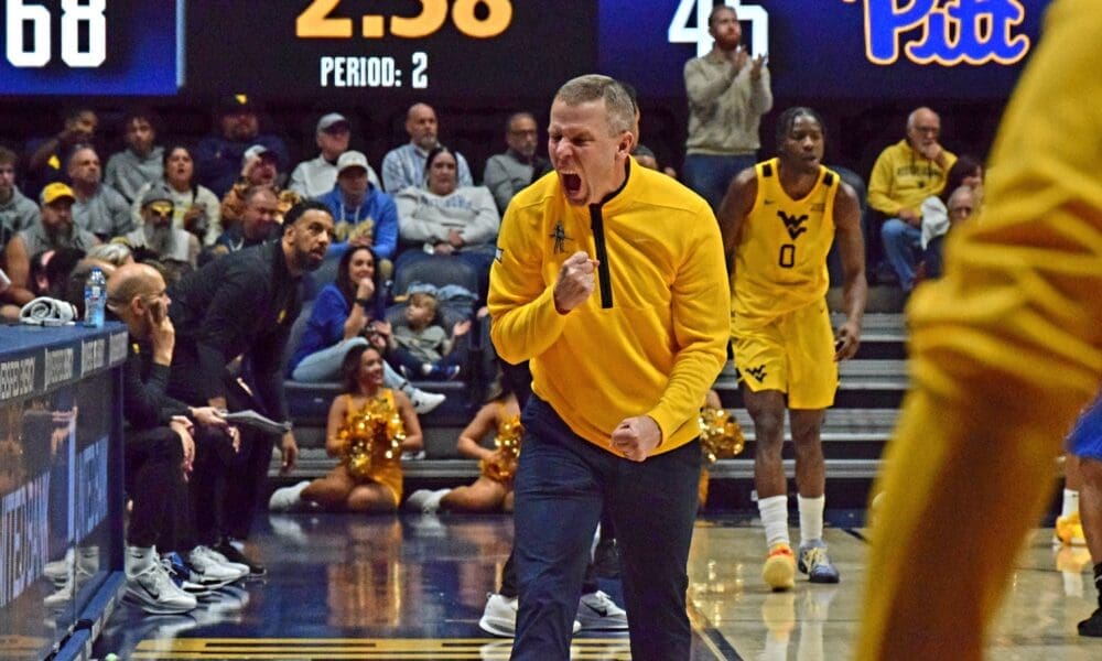 WVU Basketball Head Coach Ross Hodge screaming after beating Pitt in Backyard Brawl