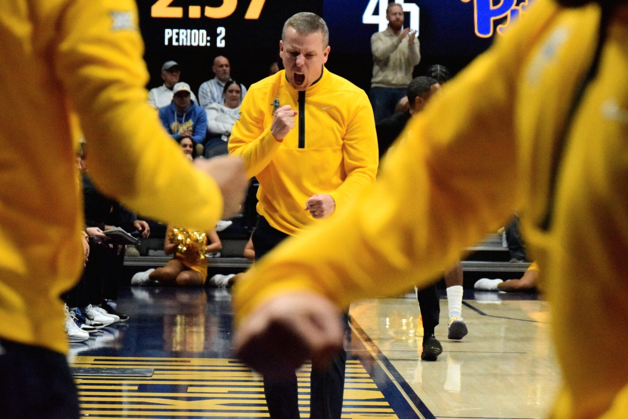 WVU Basketball Head Coach Ross Hodge screaming after beating Pitt in Backyard Brawl