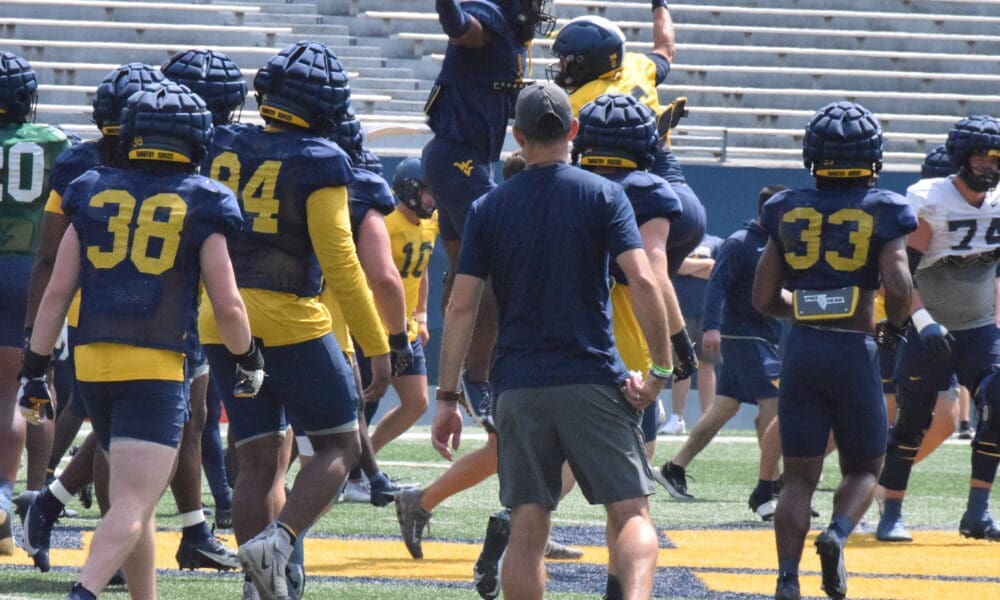 WVU Football’s Garrett Greene and Lee Kpogba have some fun during practice