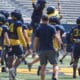WVU Football’s Garrett Greene and Lee Kpogba have some fun during practice