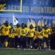 WVU Football team running on field Backyard Brawl