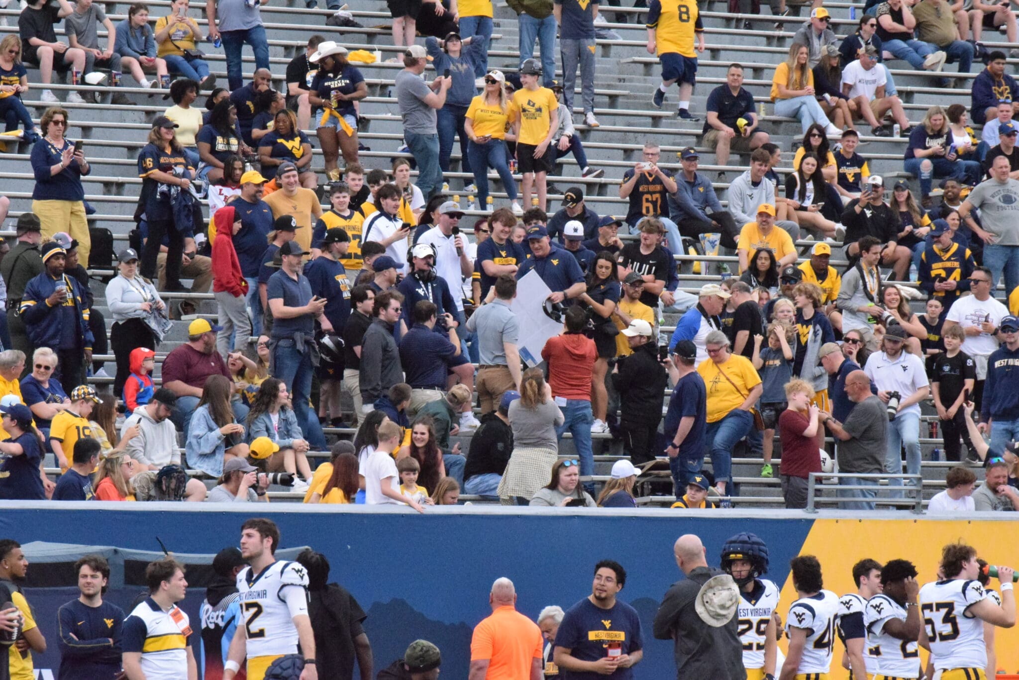 WVU Football Rich Rodriguez in stands with fans during spring showcase
