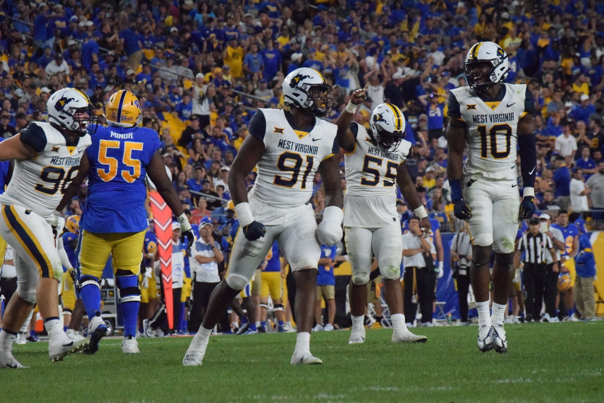 WVU football defense of Sean Martin, Dante Stills and Jared Bartlett